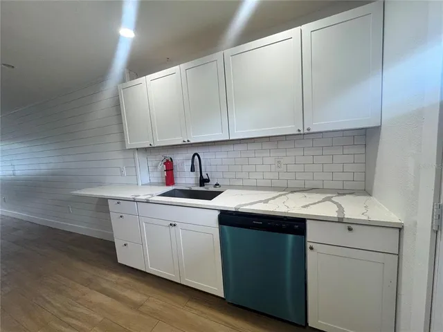 a kitchen with a refrigerator a sink and dishwasher