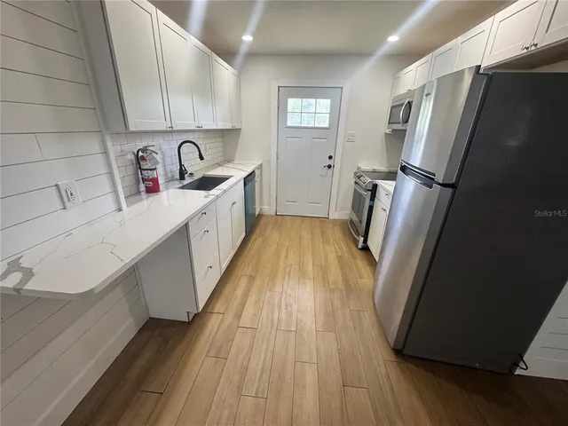 a view of kitchen view with wooden floor