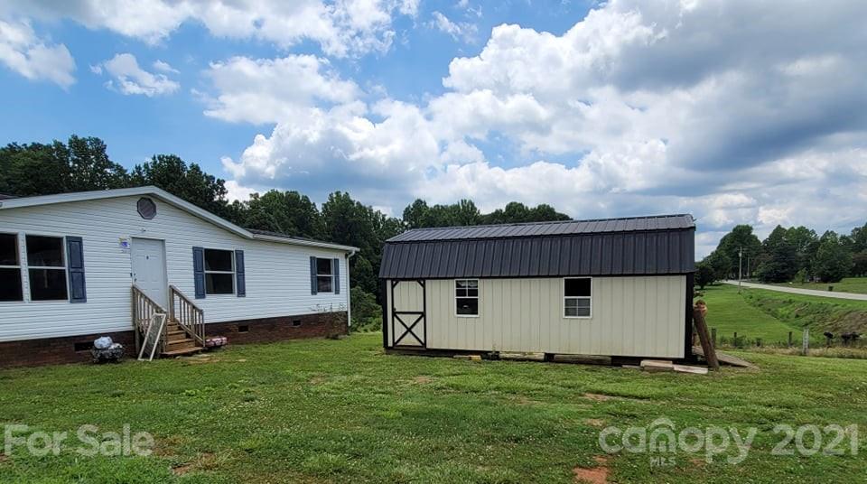 525 Baker Mill Road Cleveland, NC 27013 - Photo 2 of 35 a house with green field in front of it