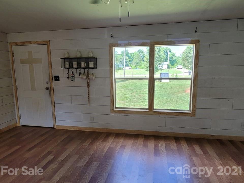 525 Baker Mill Road Cleveland, NC 27013 - Photo 15 of 35 an empty room with wooden floor and windows
