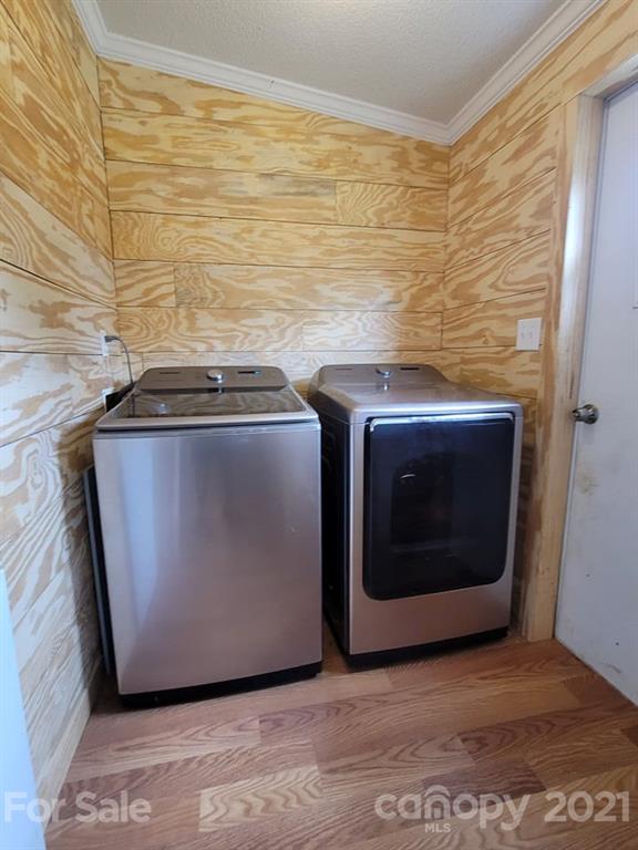 525 Baker Mill Road Cleveland, NC 27013 - Photo 23 of 35 a utility room with stainless steel appliances wooden floor and a fireplace