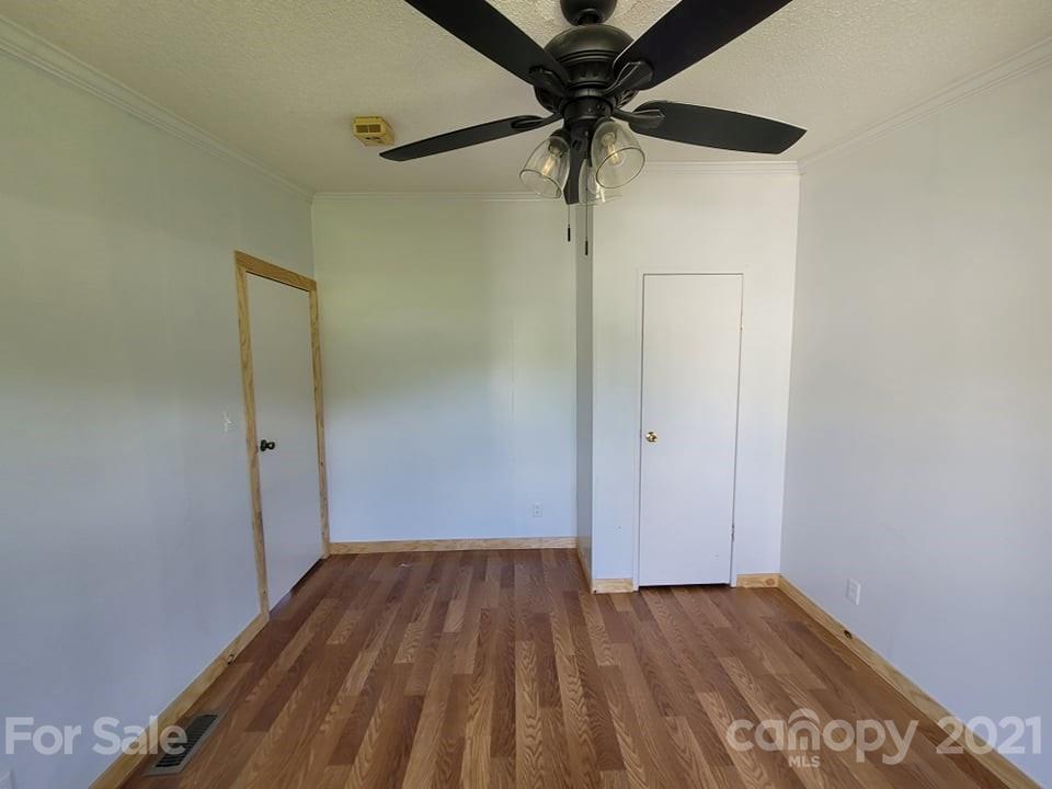 525 Baker Mill Road Cleveland, NC 27013 - Photo 33 of 35 an empty room with a hardwood and a ceiling fan