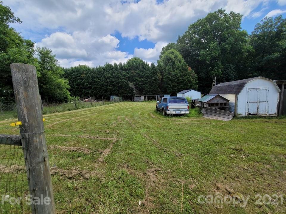 525 Baker Mill Road Cleveland, NC 27013 - Photo 6 of 35 a backyard of a house with table and chairs