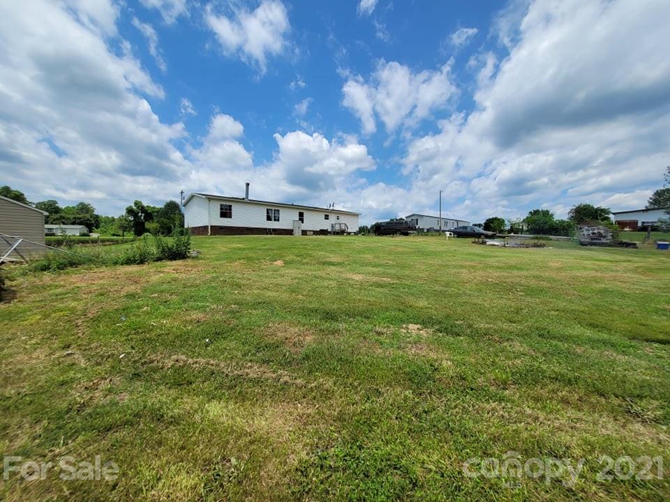 525 Baker Mill Road Cleveland, NC 27013 - Photo 8 of 35 a view of a big yard with a house in the background