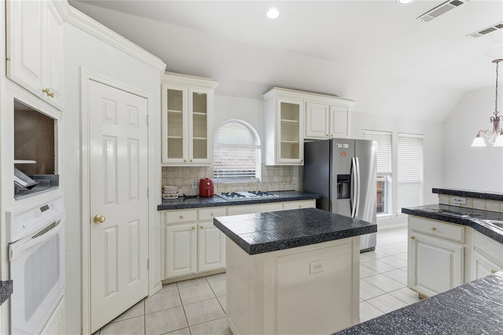 2505 Timber Ridge Drive Garland, TX 75044 - Photo 13 of 38 a kitchen with granite countertop a refrigerator stove and sink