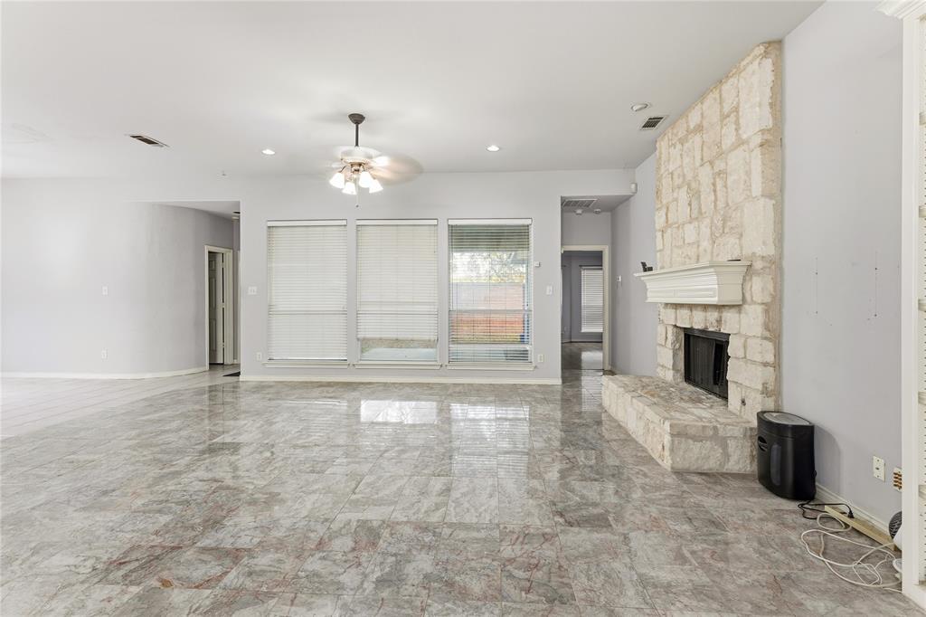 2505 Timber Ridge Drive Garland, TX 75044 - Photo 17 of 38 an empty room with fireplace cabinet and windows
