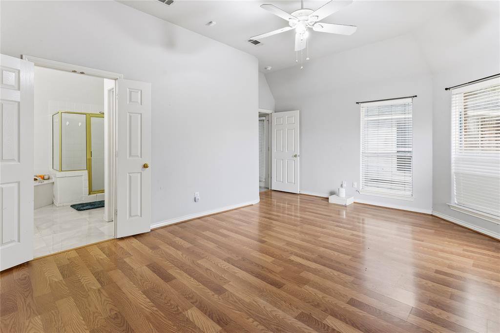 2505 Timber Ridge Drive Garland, TX 75044 - Photo 20 of 38 an empty room with wooden floor and white walls