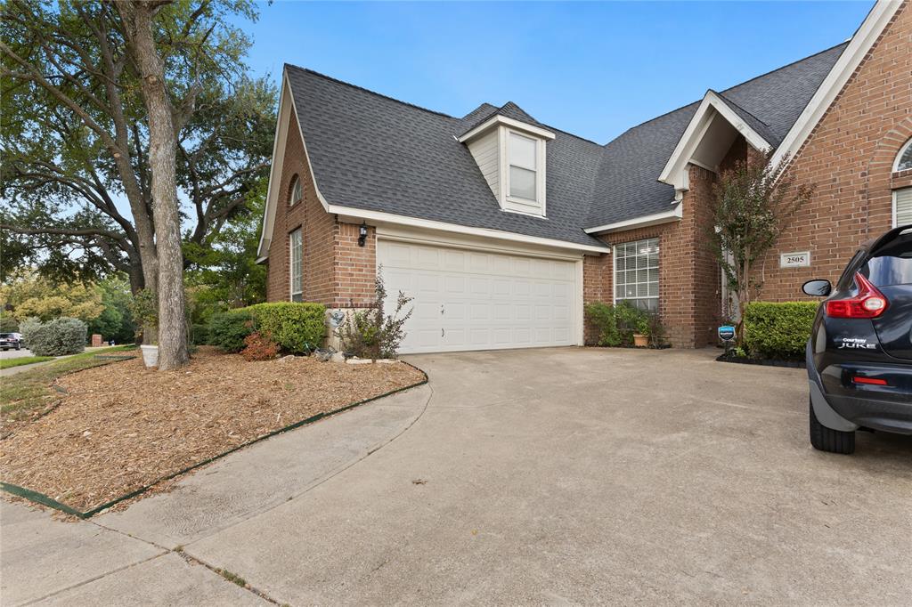 2505 Timber Ridge Drive Garland, TX 75044 - Photo 2 of 38 a view of a house with a yard and garage
