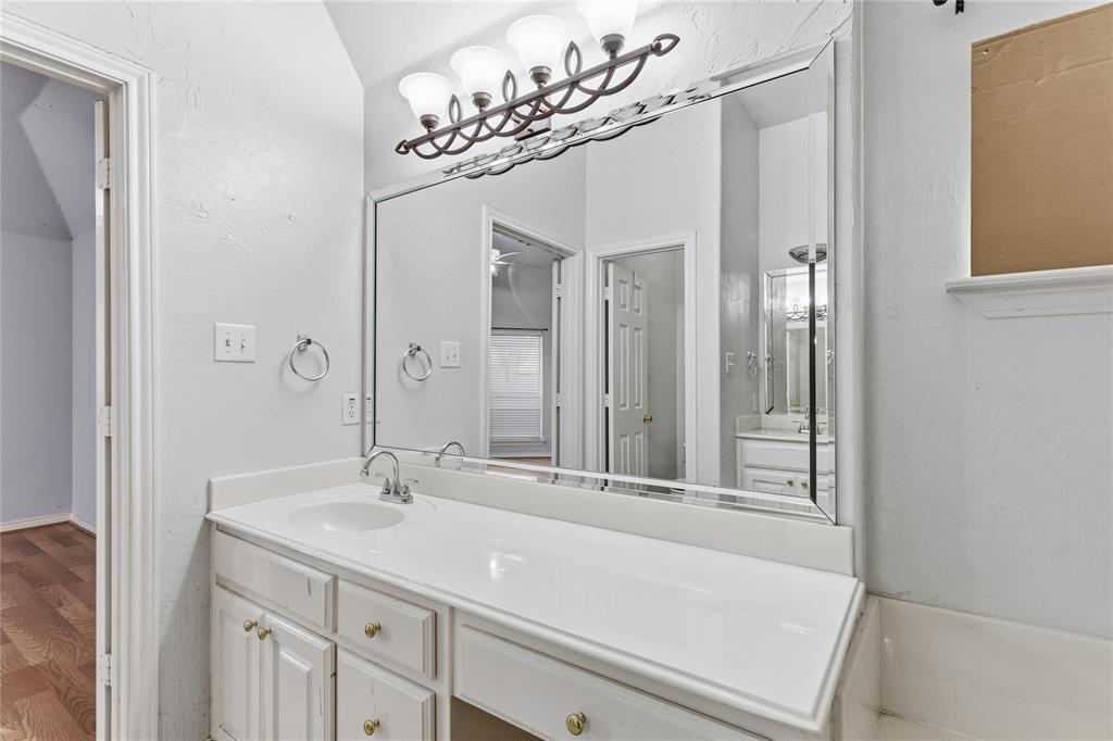 2505 Timber Ridge Drive Garland, TX 75044 - Photo 21 of 38 a bathroom with a sink a vanity and a mirror
