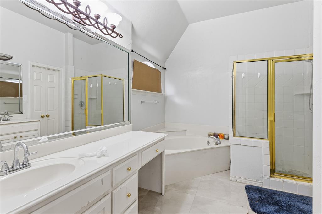 2505 Timber Ridge Drive Garland, TX 75044 - Photo 23 of 38 a bathroom with a tub sink and mirror