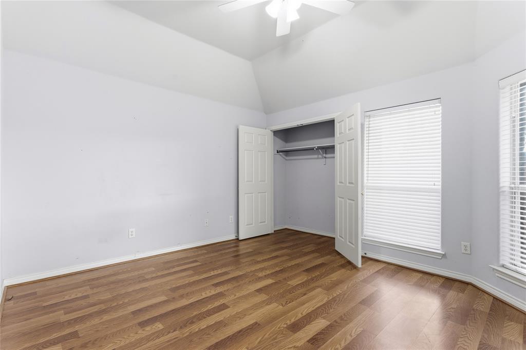 2505 Timber Ridge Drive Garland, TX 75044 - Photo 29 of 38 an empty room with wooden floor cabinet and windows