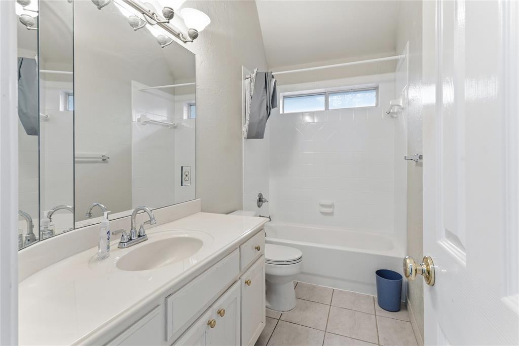 2505 Timber Ridge Drive Garland, TX 75044 - Photo 32 of 38 a bathroom with a sink a toilet and shower