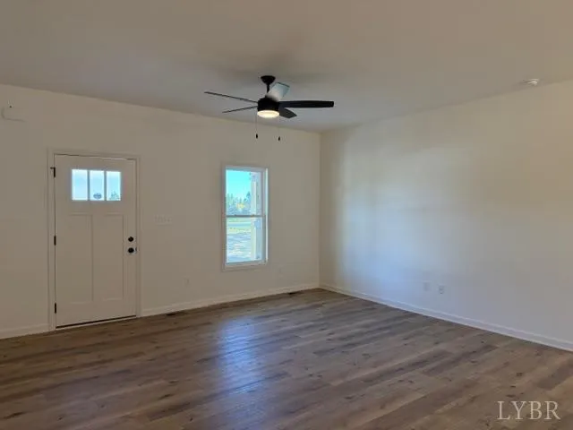 wooden floor in an empty room with a window