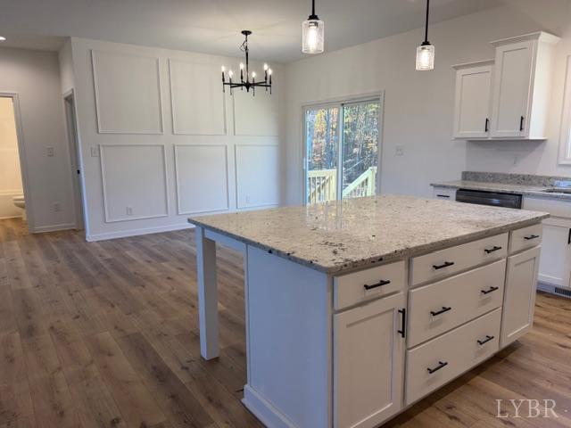 689 Robinson Road Appomattox, VA 24522 - Photo 6 of 16 a kitchen with granite countertop cabinets and wooden floor