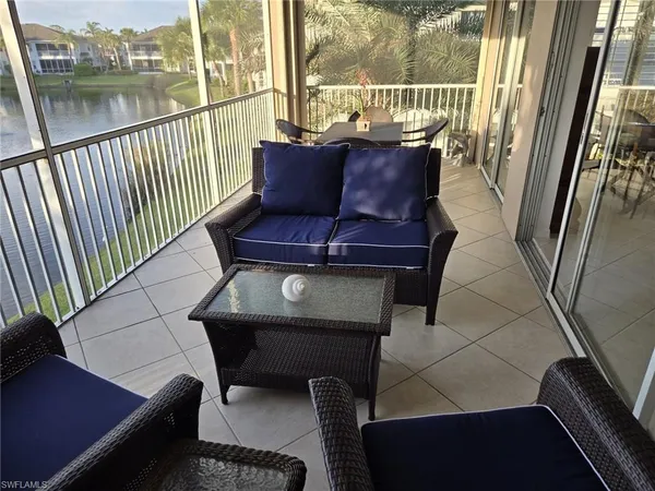 a view of a chairs and table in a balcony