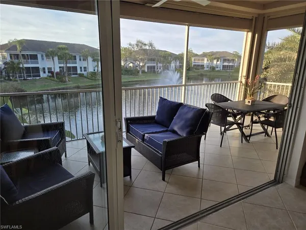 a view of a chairs and table in the balcony