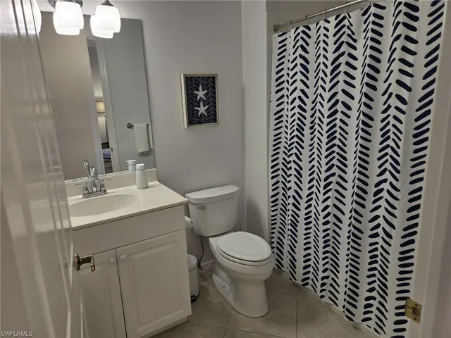 a white toilet sitting next to a bathroom sink
