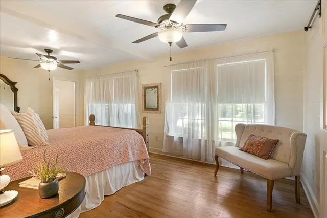 a spacious bedroom with a bed furniture and a window