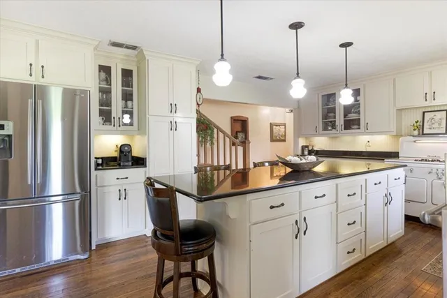 a kitchen with white cabinets and stainless steel appliances