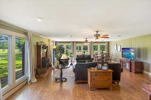 a living room with furniture and large windows