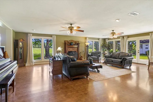 a living room with furniture a fireplace and a table