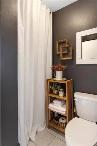 a bathroom with a toilet a sink and a mirror