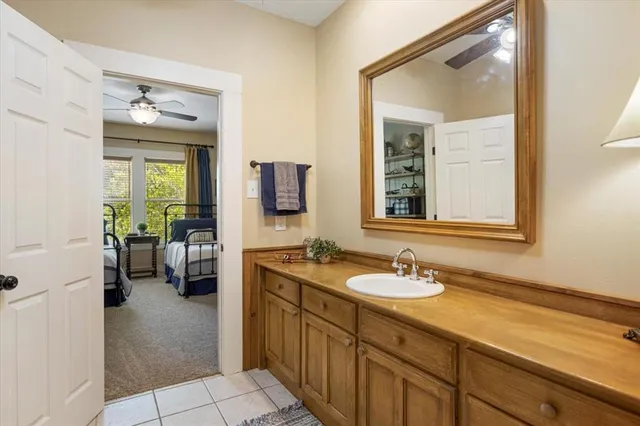 a en suite bathroom with a sink double vanity and a mirror