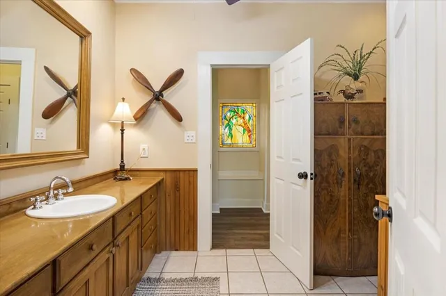 a bathroom with a sink a mirror and a shower