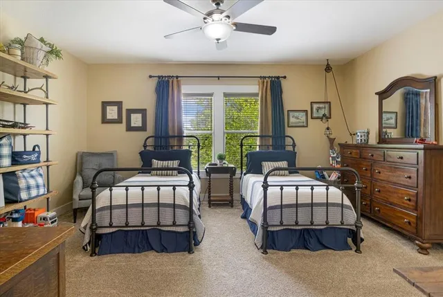 a bedroom with two beds and a dresser