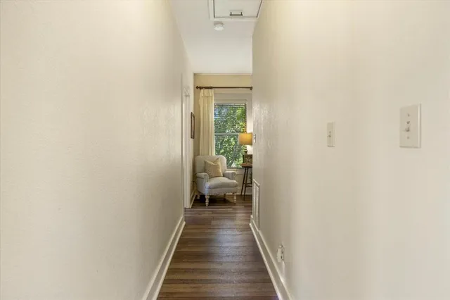 a view of a hallway with wooden floor and a hallway