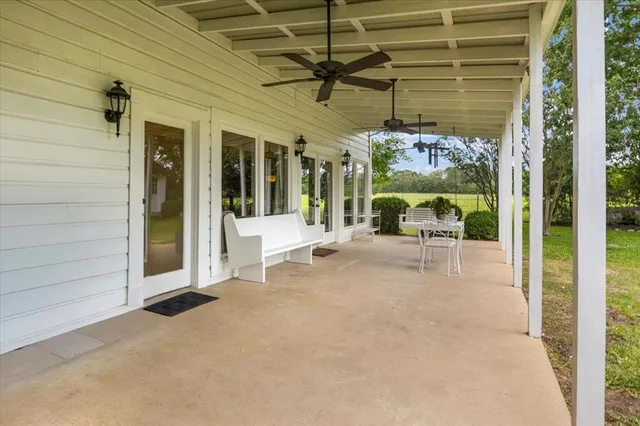 a building outdoor space with porch and furniture