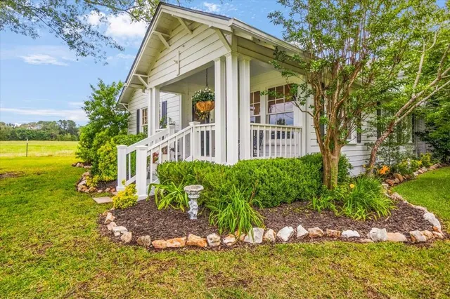 a front view of a house with garden