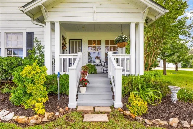a front view of a house with garden