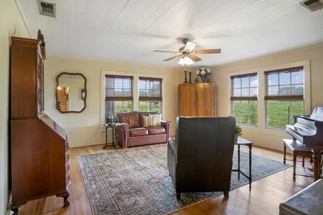 a living room with furniture a table and large window