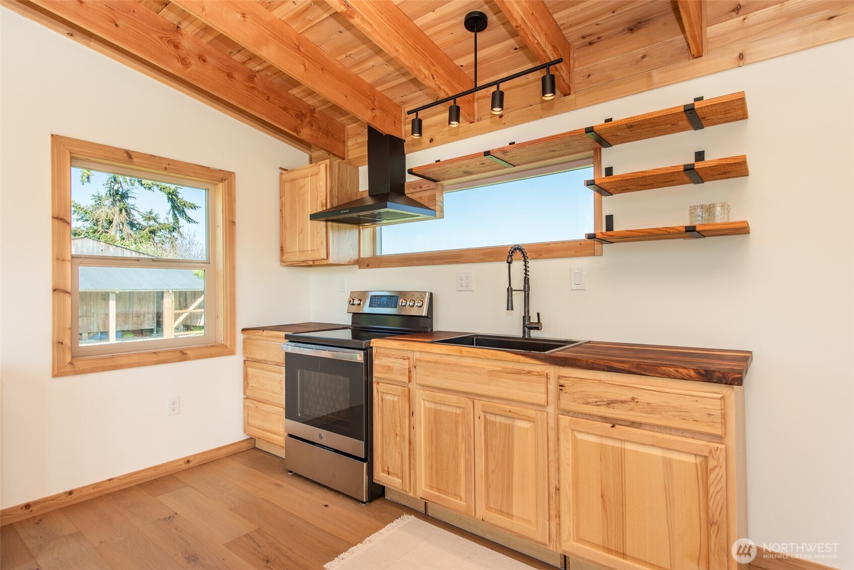 148 Gunn Road Port Angeles, WA 98362 - Photo 22 of 38 a kitchen with stainless steel appliances granite countertop a sink a stove and cabinets