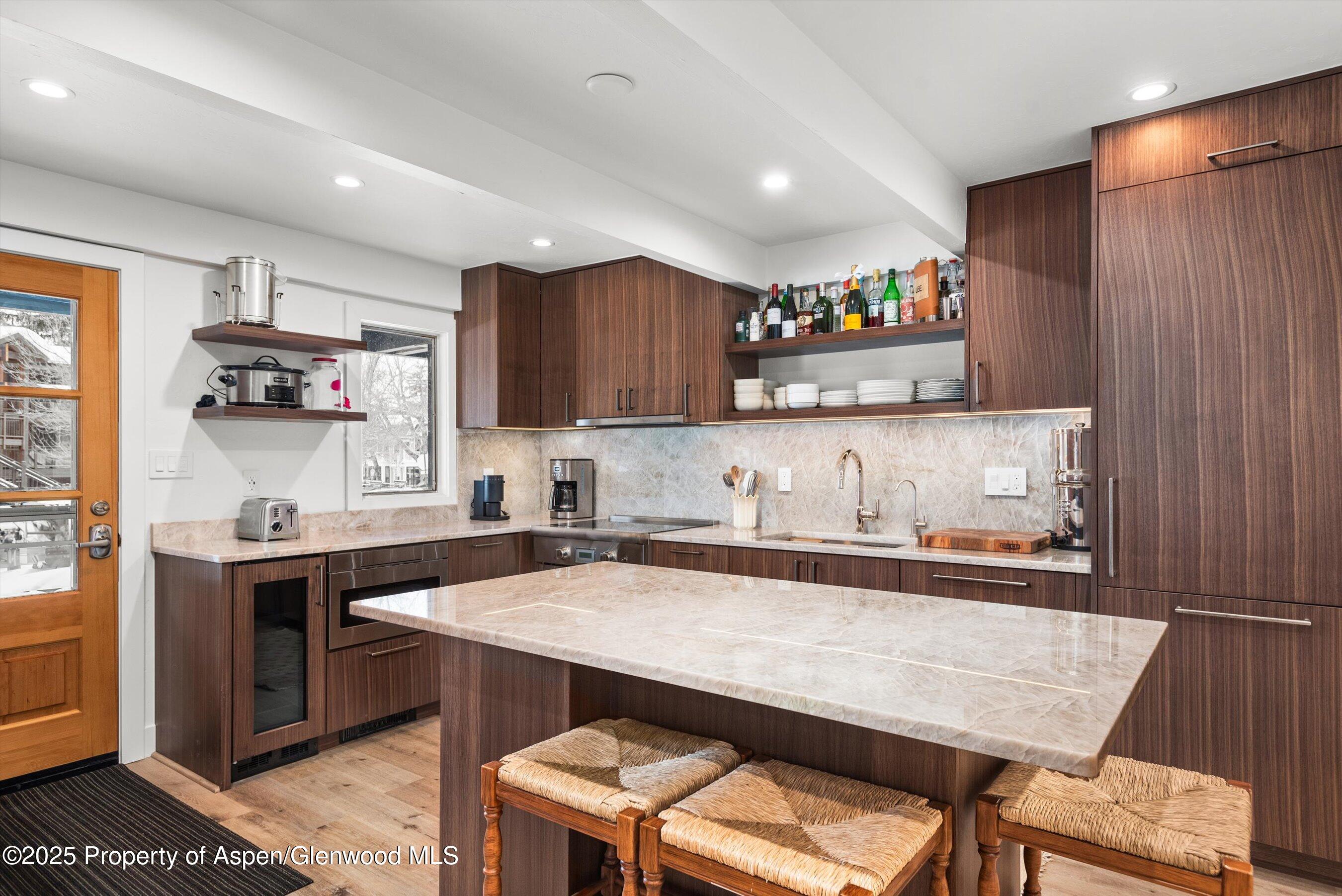 901 East Hyman Avenue, Unit 1 Aspen, CO 81611 - Photo 2 of 12 a kitchen with stainless steel appliances granite countertop a sink counter space and cabinets