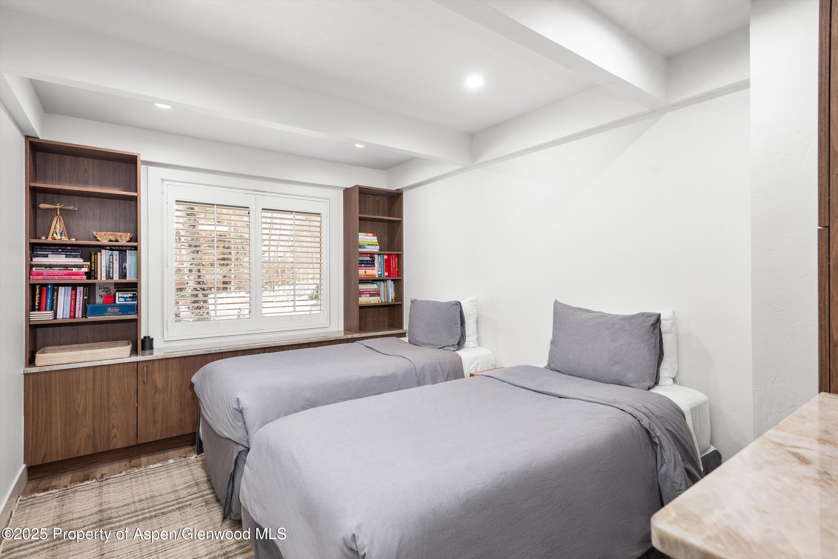 901 East Hyman Avenue, Unit 1 Aspen, CO 81611 - Photo 5 of 12 a bedroom with a large bed and a closet