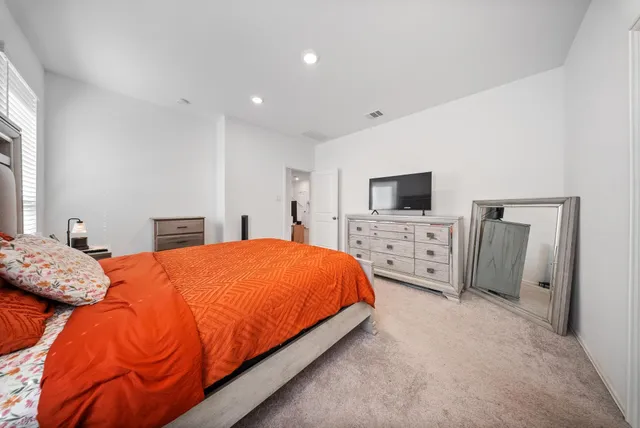 a bed room with a bed and a television