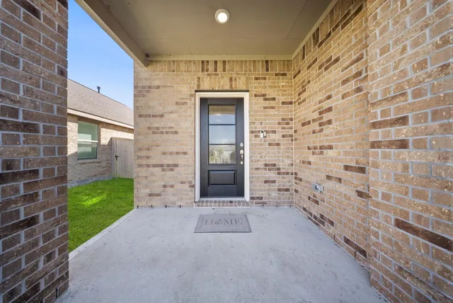 a view of a brick house with a large door