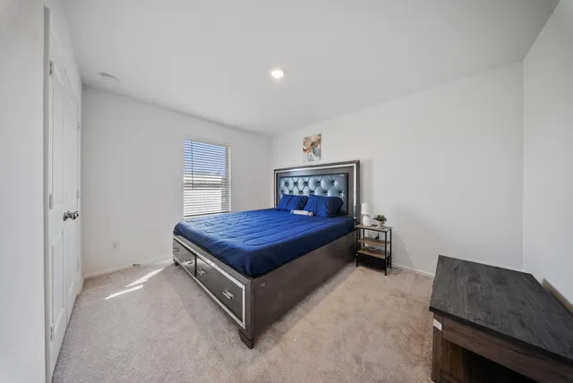 a bedroom with a bed and a desk in it