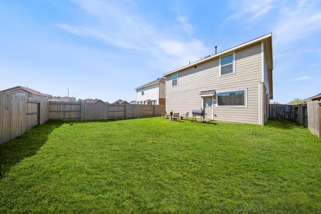 a view of a backyard with seating area and barbeque oven