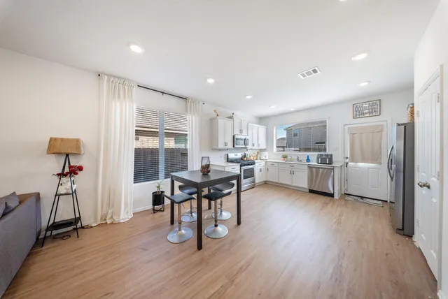 a living room with furniture and a wooden floor
