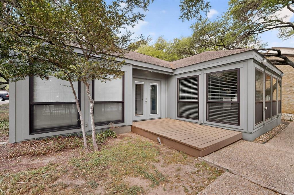 8210 Bent Tree Road, Unit 116 Austin, TX 78759 - Photo 17 of 21 Mature trees frame a charming wooden deck and concrete walkway leading to the back entrance.