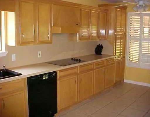 a kitchen with stainless steel appliances granite countertop a sink and a cabinets