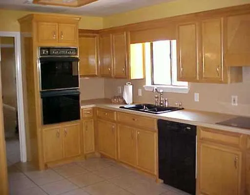 a kitchen with a refrigerator and a sink