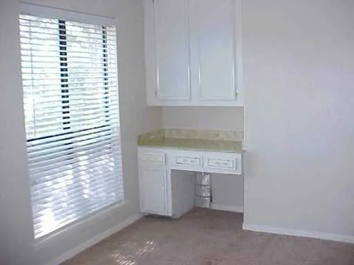 a room with a white cabinets and a fireplace