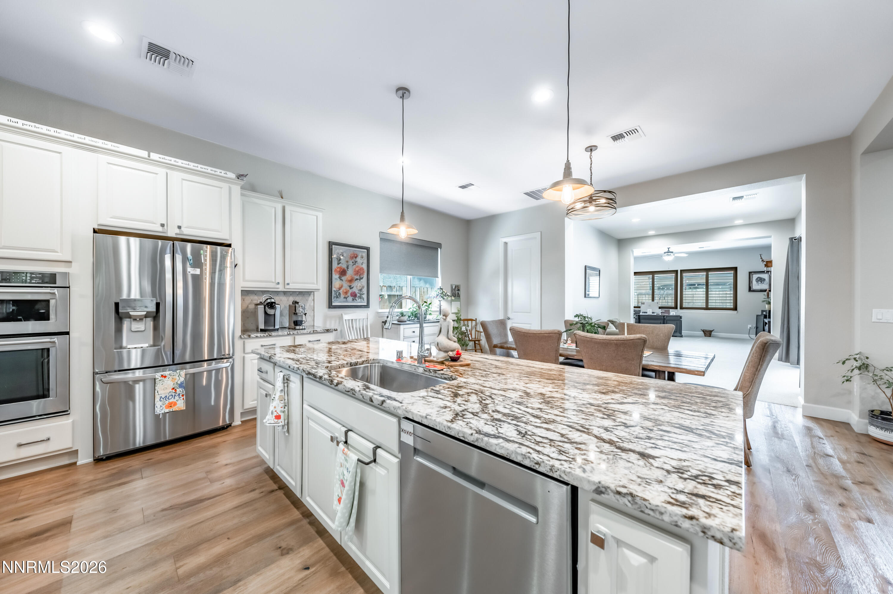2468 Sparstone Drive Reno, NV 89521 - Photo 5 of 39 a large kitchen with kitchen island a large counter space appliances and wooden floor