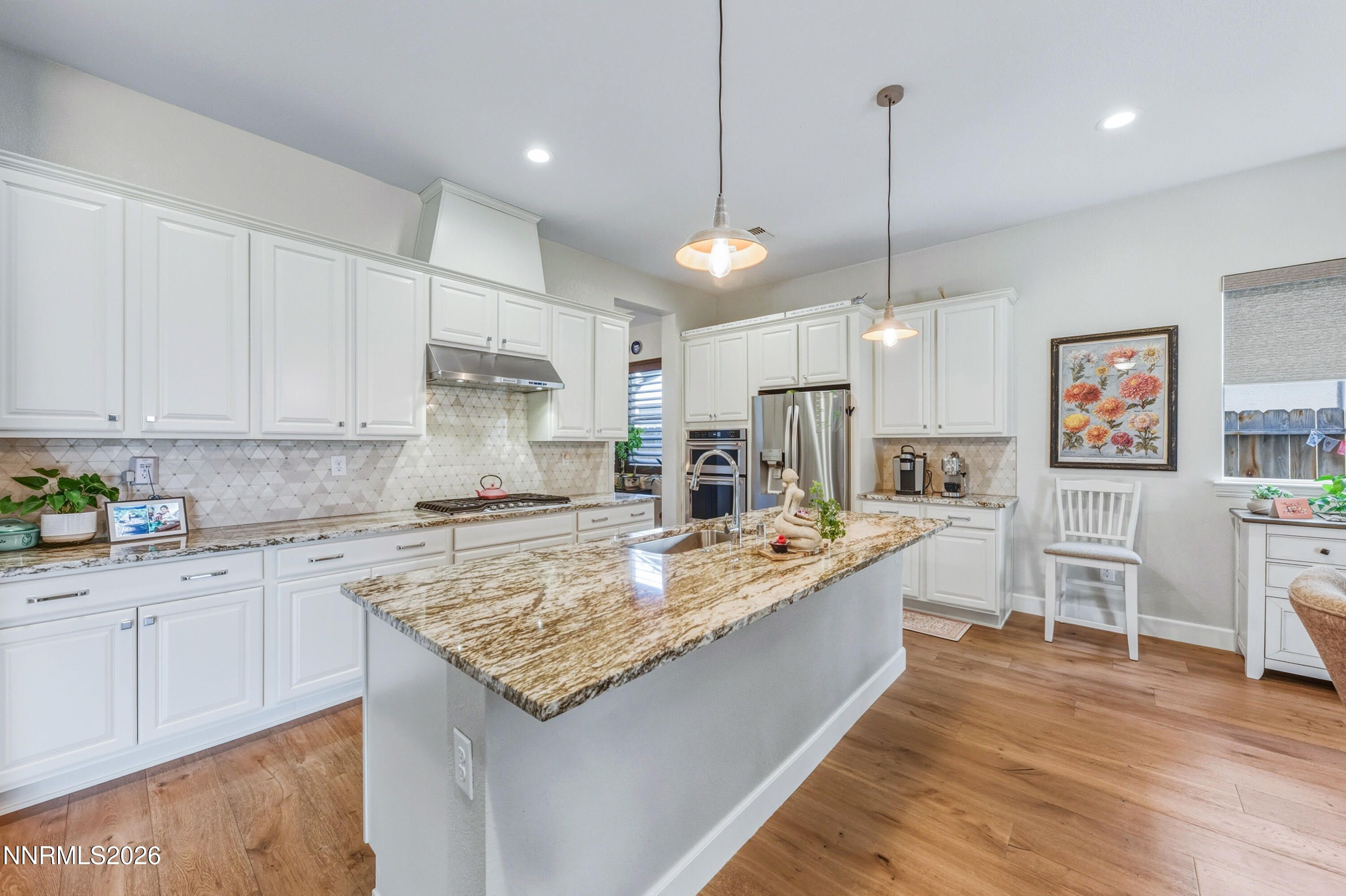 2468 Sparstone Drive Reno, NV 89521 - Photo 6 of 39 a large kitchen with kitchen island a large counter space a sink and appliances