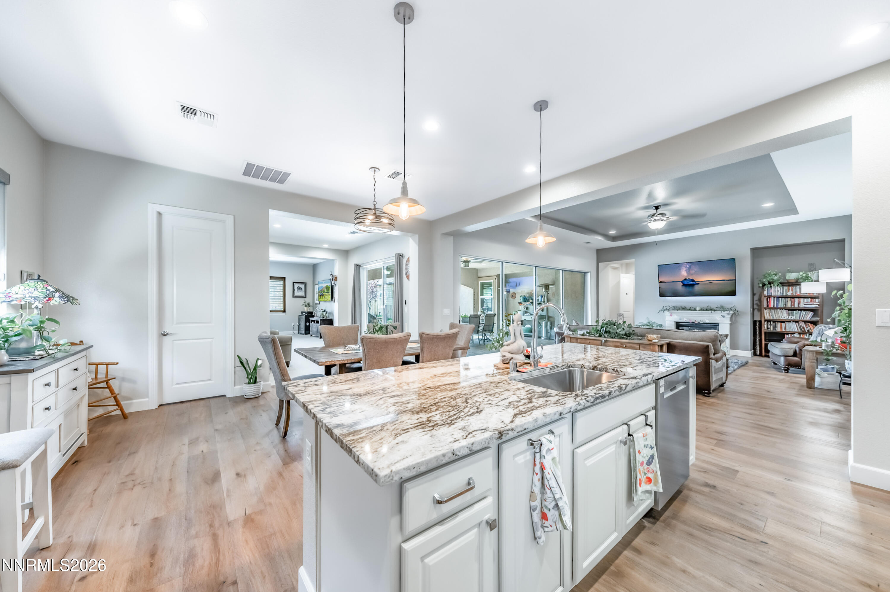 2468 Sparstone Drive Reno, NV 89521 - Photo 10 of 39 a view of center island of a kitchen with granite countertop living room and wooden floor