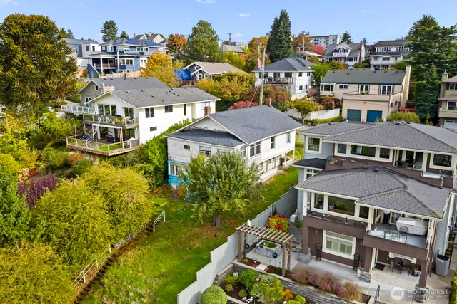 an aerial view of multiple houses with a yard